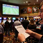 Excited bettor analyzing live odds for keo nha cai hom nay in a vibrant sports betting area.